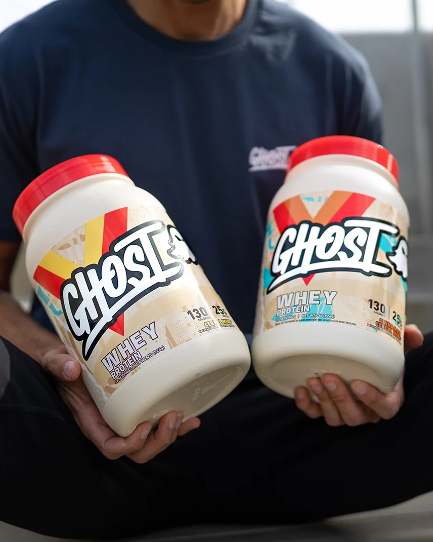 Two GHOST® WHEY tubs held side by side