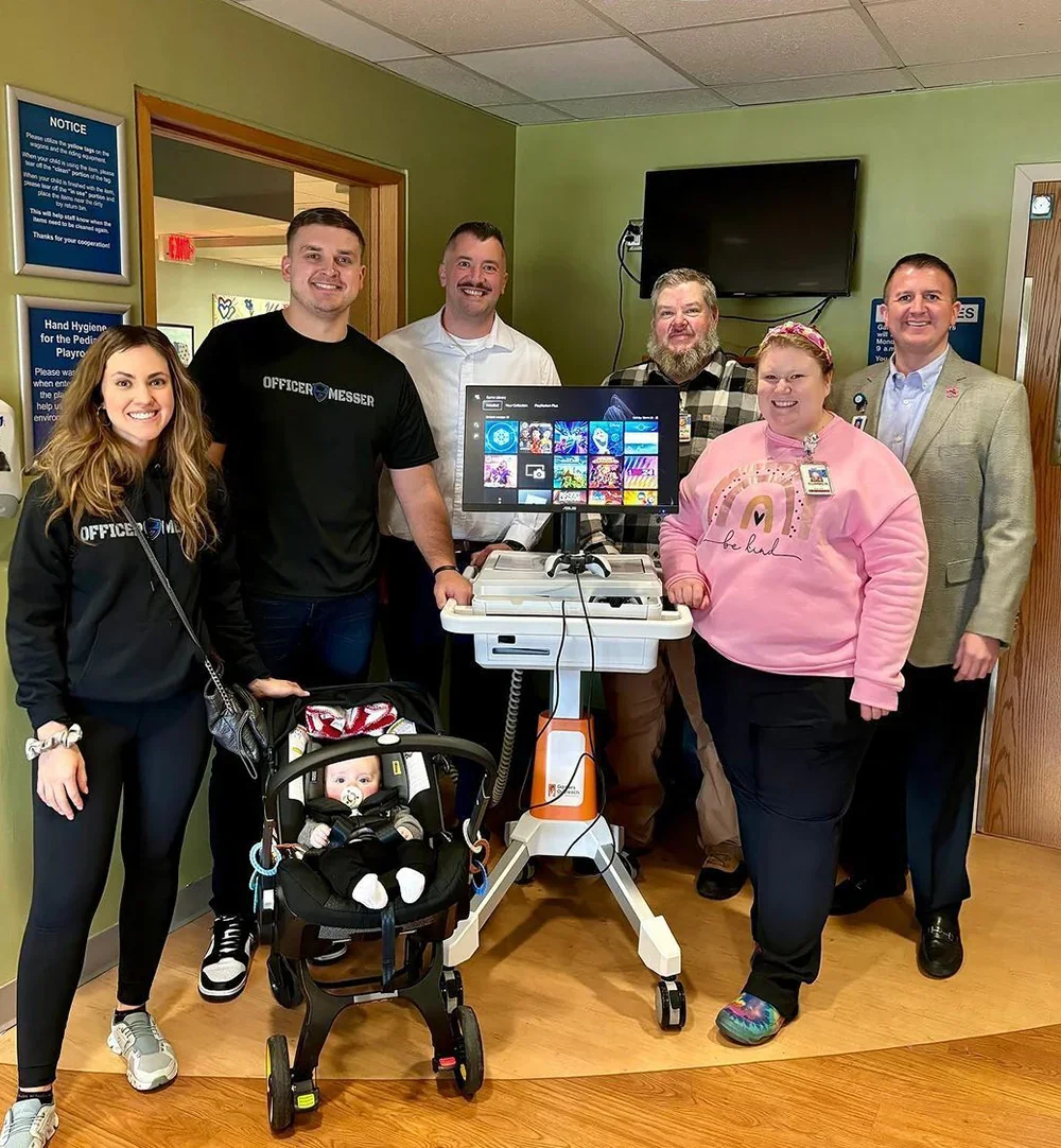 GHOST® team and hospital staff beside a Gamers Outreach gaming cart