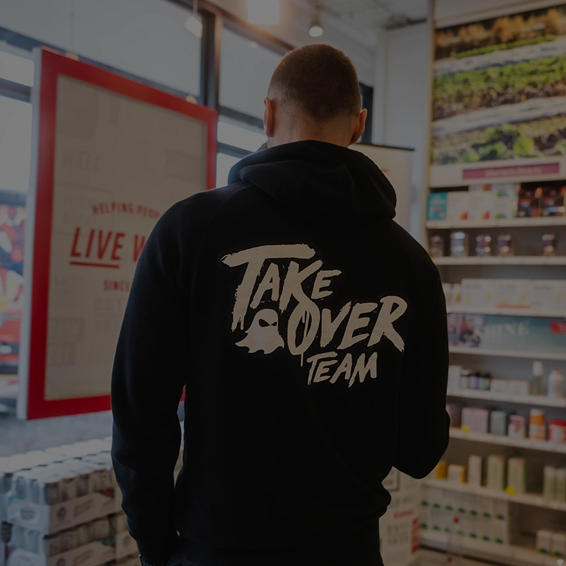 Back of a Takeover Team hoodie inside a retail store